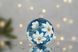 Christmas tree ball "White magnolia on blue"